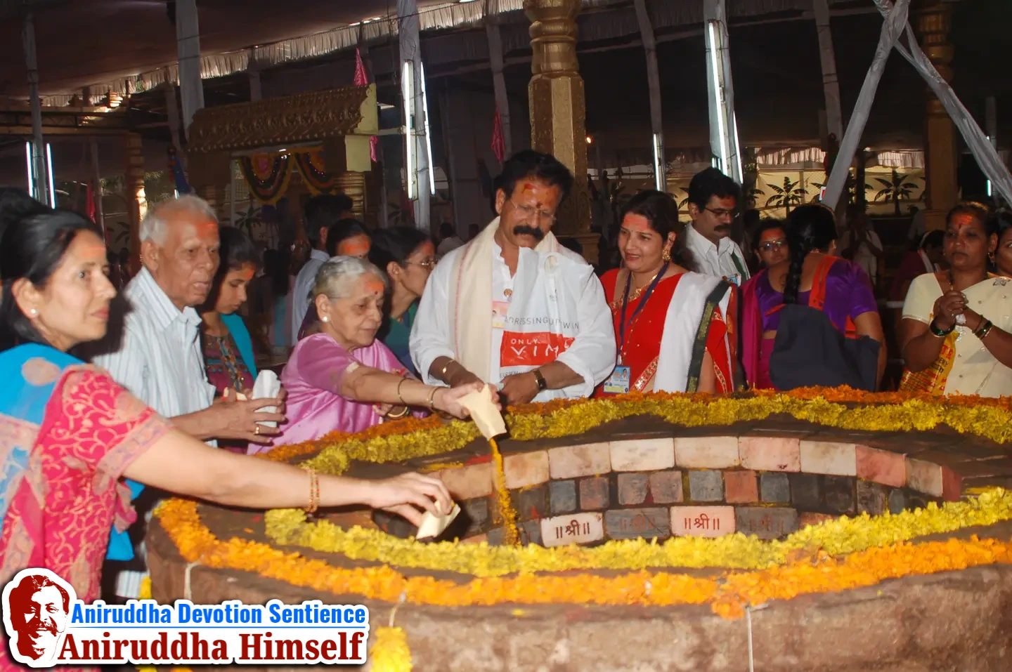 Shraddhavans offer Mangaldravya (a mixture of haldi, kumkum and abeer) to the sacred MahaSaraswati Vapi during Shree Varadachandika Prasannotsav at Shree Harigurugram in 2011.