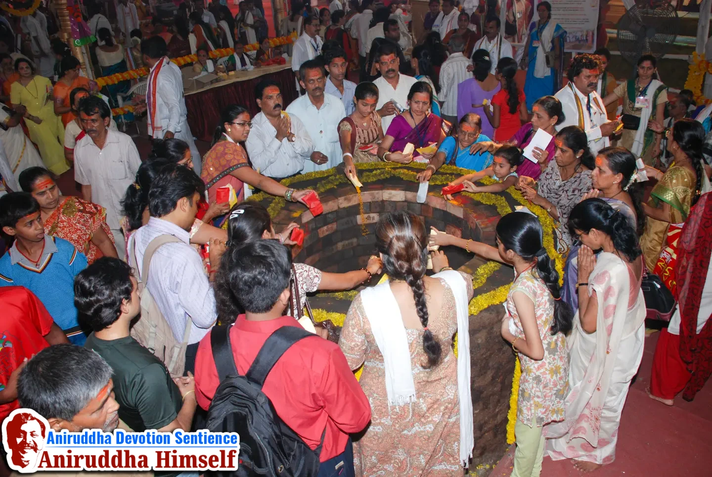 Shraddhavans offer Mangaldravya (a mixture of haldi, kumkum and abeer) to the sacred MahaSaraswati Vapi during Shree Varadachandika Prasannotsav at Shree Harigurugram in 2011.